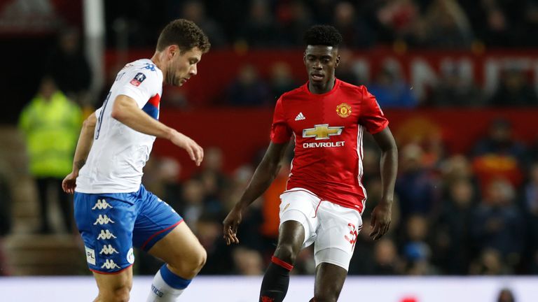 Manchester United's Axel Tuanzebe (right) and Wigan Athletic's Yanic Wildschut battle for the ball in the FA Cup