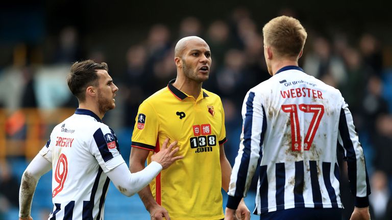 Millwall's Lee Gregory holds back Watford's Younes Kaboul as he exchanges words with Byron Webster 