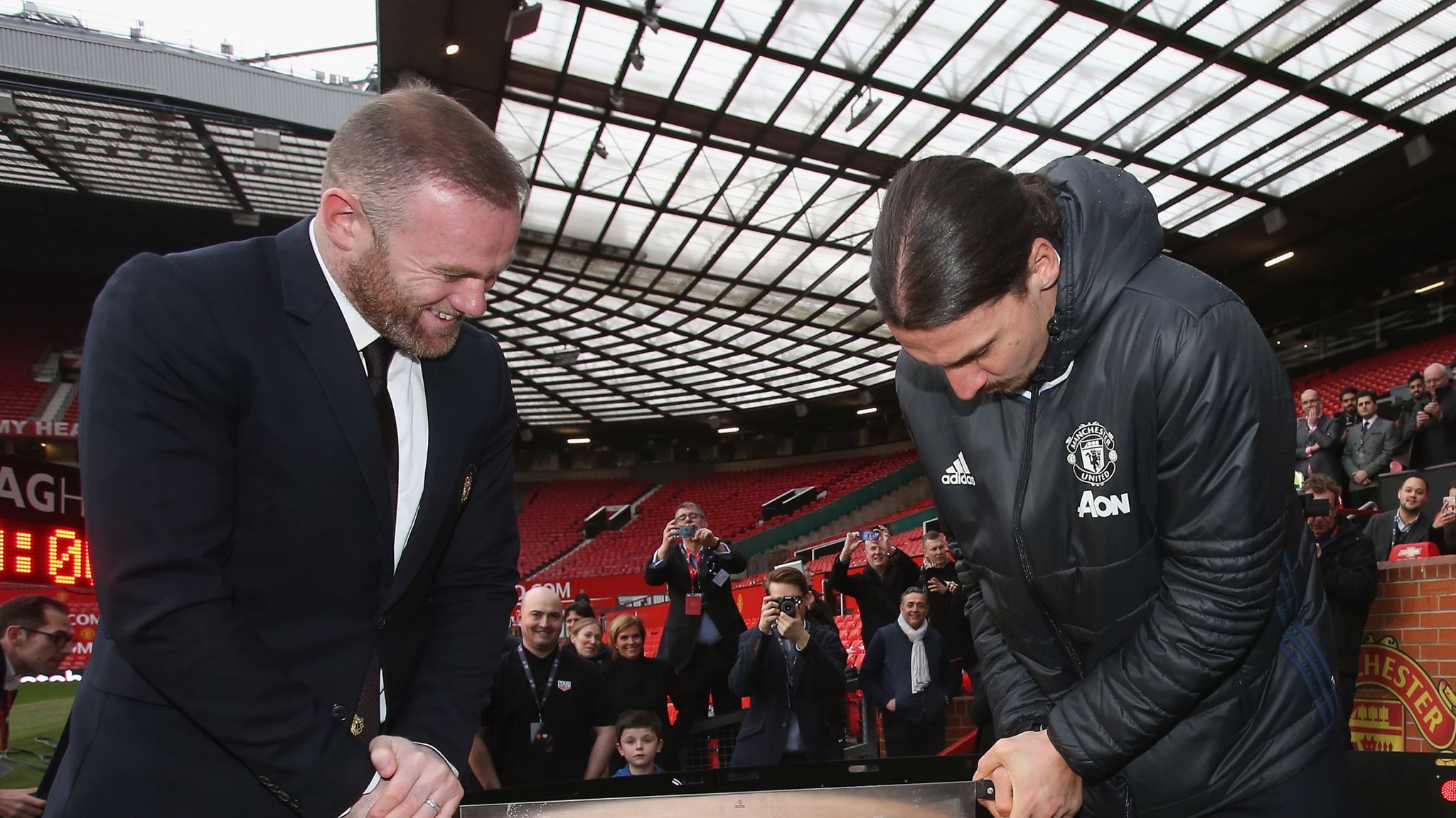 Manchester United's Wayne Rooney and Zlatan Ibrahimovic cut a giant CHEESE  on the pitch to help show off the new club TAG Heuer watches (but boss Jose  Mourinho looked glum in the