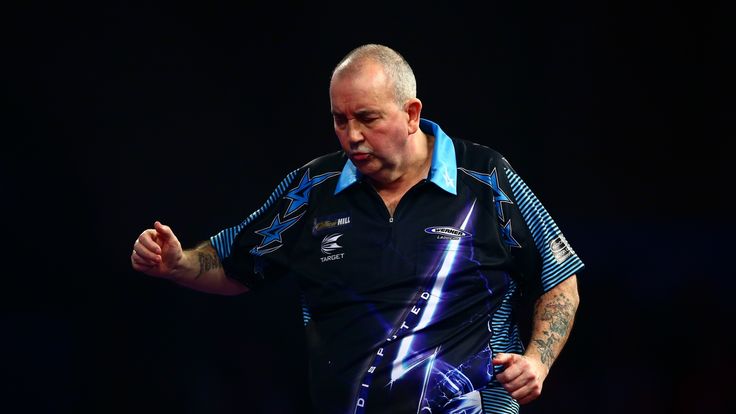 Phil Taylor of England looks dejected in his third round match against Jelle Klaasen