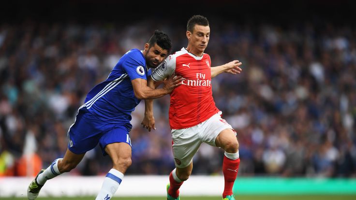 LONDON, ENGLAND - SEPTEMBER 24:  Diego Costa of Chelsea (L) and Laurent Koscielny of Arsenal (R) battle for possession during the Premier League match betw