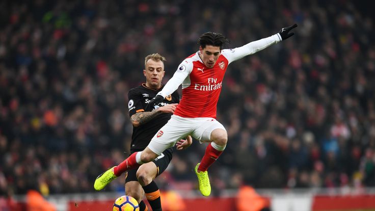Hector Bellerin of Arsenal and Kamil Grosicki of Hull City compete for the ball