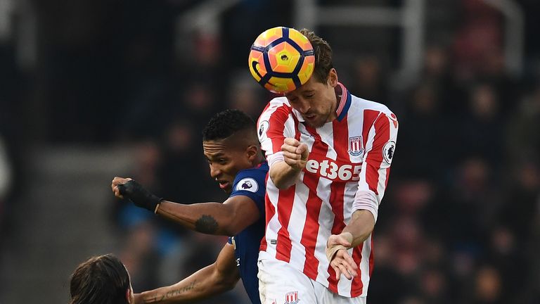 JANUARY 21 2017:  Peter Crouch wins a header against Antonio Valencia during the Premier League match between Stoke City and Manchester United