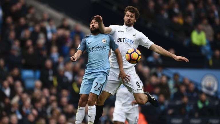 Swansea City striker Fernando Llorente (R) vies with Manchester City  defender Gael Clichy (L) during a Premier League football match in February 2017