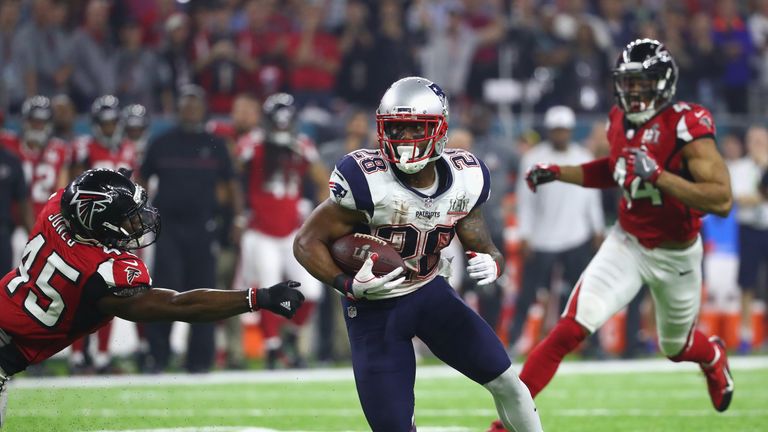 HOUSTON, TX - FEBRUARY 05: James White #28 of the New England Patriots evades a tackle by Deion Jones #45 of the Atlanta Falcons  during Super Bowl 51 at N