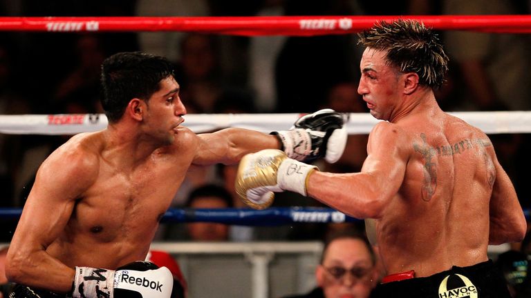 NEW YORK - MAY 15:  Amir Khan (L) of Great Britain and Paulie Malignaggi exchange blows during the WBA light welterweight title fight at Madison Square Gar