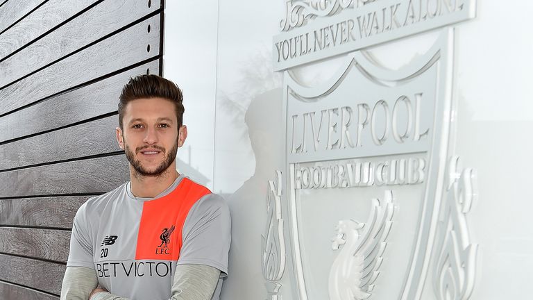 Adam Lallana poses for a photograph at Melwood after signing a new contract