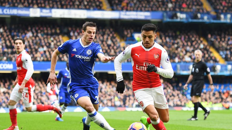 LONDON, ENGLAND - FEBRUARY 04:  Alexis Sanchez of Arsenal runs with the ball under pressure from Cesar Azpilicueta of Chelsea during the Premier League mat