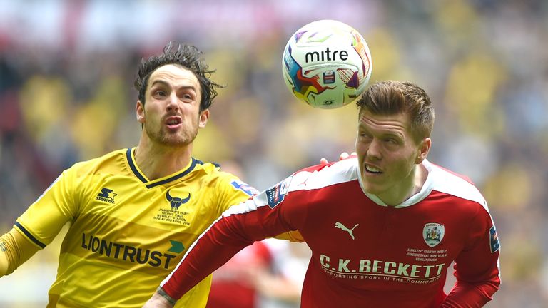 Danny Hylton and Alfie Mawson in action during the Johnstone's Paint Trophy Final between Oxford United and Barnsley