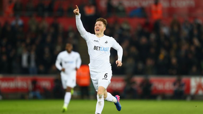 SWANSEA, WALES - FEBRUARY 12:  Alfie Mawson of Swansea City celebrates as he scores their first goal during the Premier League match between Swansea City a