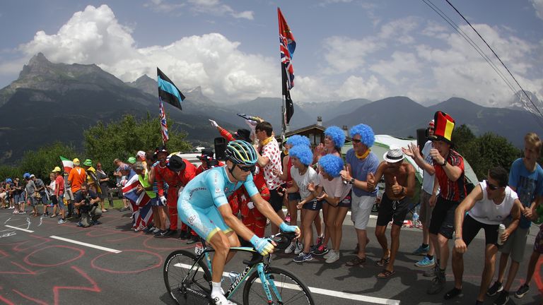 MEGEVE, FRANCE - JULY 21: supporters watch on as Andrei Grivko of Ukraine and Astana Pro Team rides during stage eighteen of the 2016 Le Tour de France, fr