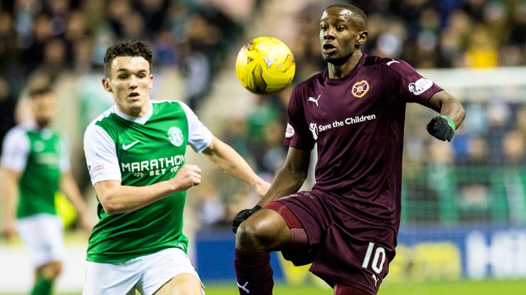 Hibernian's John McGinn moves in to challenge Arnaud Djoum of Hearts