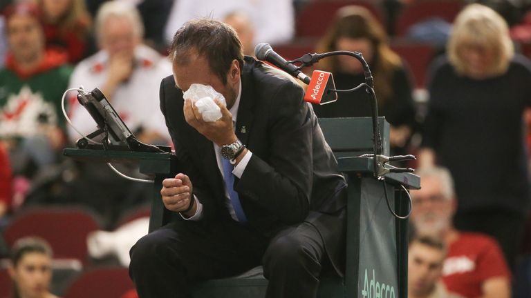 Chair umpire Arnaud Gabas reacts to getting hit in the eye by a ball hit by Denis Shapovalov