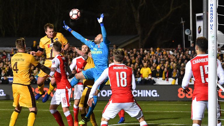 Jamie Collins heads a shot towards goal as David Ospina fails to claim during the Emirates FA Cup Fifth Round