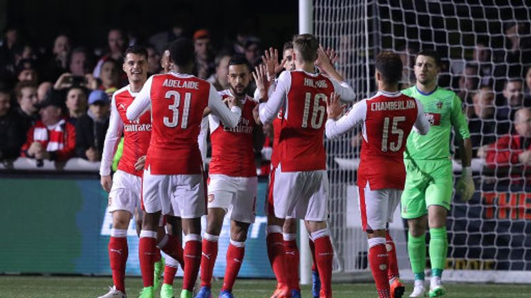 Theo Walcott is congratulated after scoring his 100th goal for Arsenal