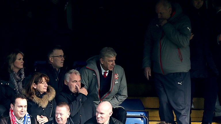 Arsene Wenger sits in the stands at Stamford Bridge while serving his touchline ban