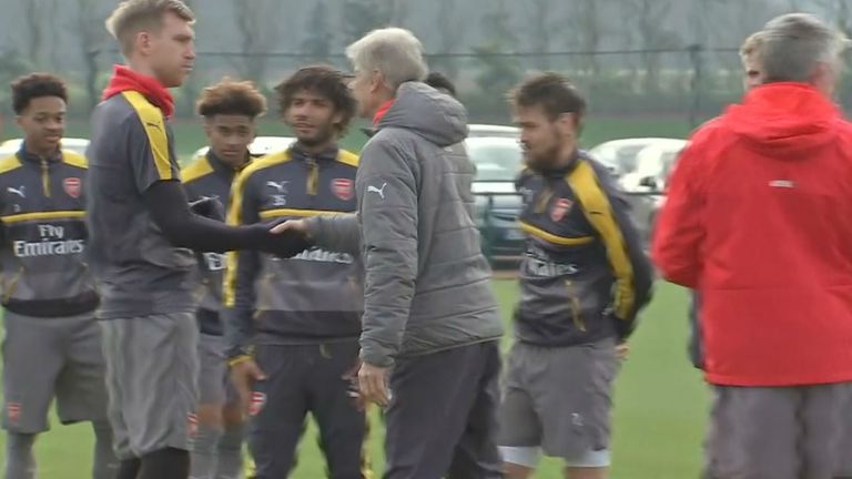 Arsene Wenger greets his players on Friday morning