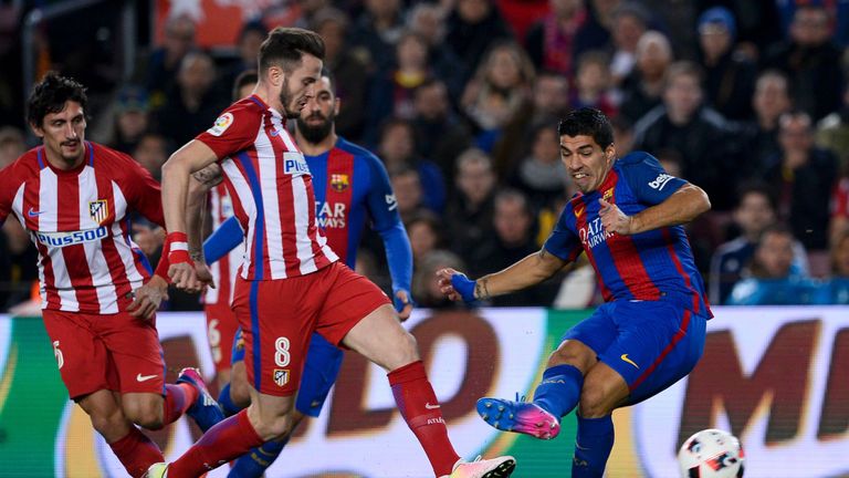 Atletico Madrid's Saul Niguez (L) vies with Barcelona's Luis Suarez during the Spanish Copa del Rey (King's Cup) semi final second leg