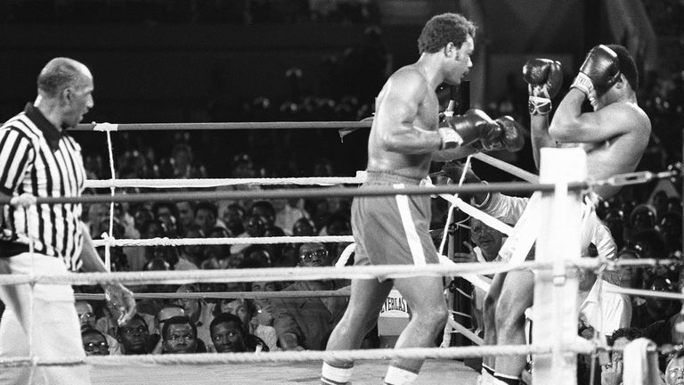 Le champion du monde de boxe des poids lourds am?ricain George Foreman (C) pousse son compatriote Muhammad Ali (Cassius Clay) (D)
