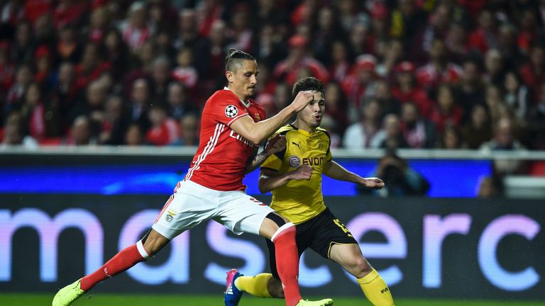Benfica's Swedish defender Victor Lindelof (L) vies with Dortmund's Portuguese defender Raphael Guerreiro during the UEFA Champions League round of 16 firs