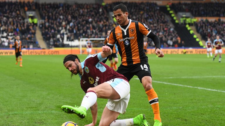 HULL, ENGLAND - FEBRUARY 25: George Boyd of Burnley (L) attempts to keep the ball in play while under pressure from Omar Elabdellaoui of Hull City (R) duri