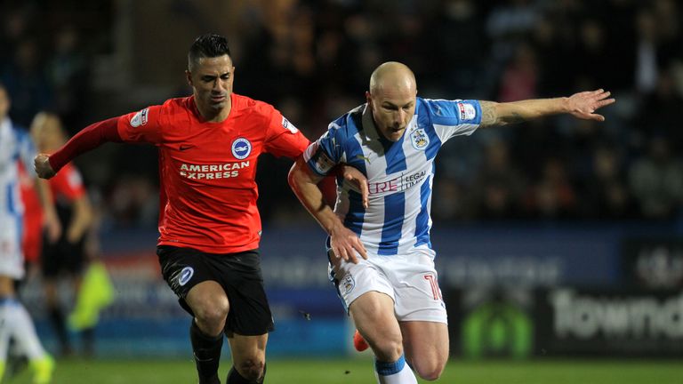 Huddersfield Town's Aaron Mooy (right) and Brighton & Hove Albion's Biram Kayal battle for the ball during the Sky Bet Championship game at the John Smith'