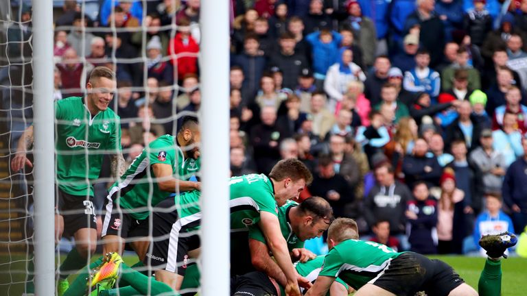 Sean Raggett celebrates after scoring Lincoln's winner