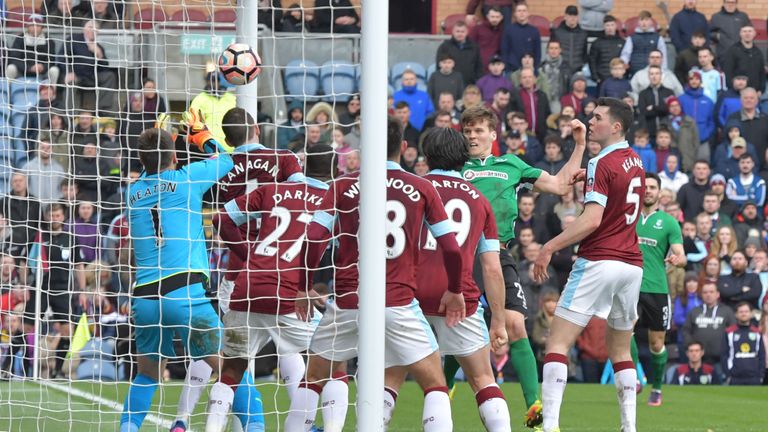 Sean Raggett (centre) heads past Tom Heaton in the 89th-minute at Turf Moor