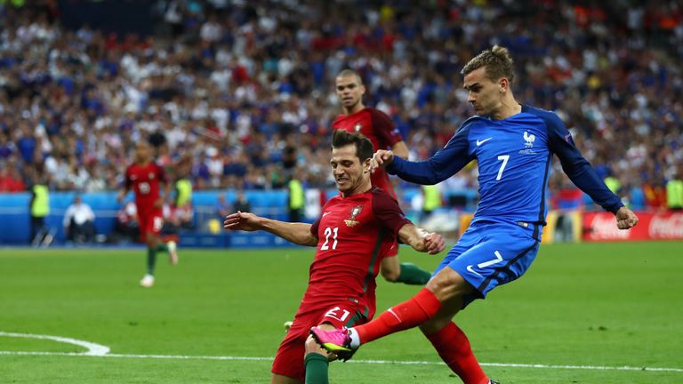 PARIS, FRANCE - JULY 10:  Antoine Griezmann of France and Cedric Soares of Portugal compete for the ball during the UEFA EURO 2016 Final match between Port