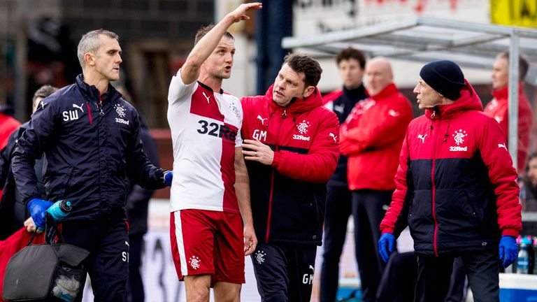 Rangers defender Clint Hill leaves the pitch after suffering whiplash at Dundee