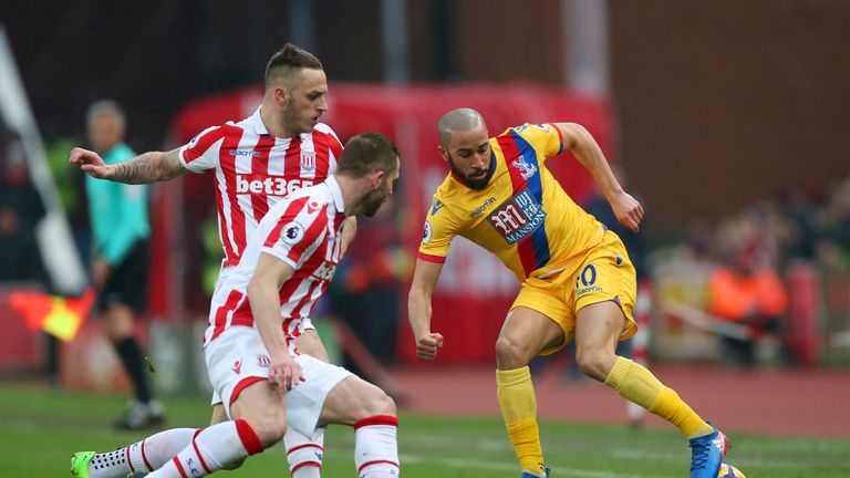 STOKE ON TRENT, ENGLAND - FEBRUARY 11:  Andros Townsend of Crystal Palace controls the ball under pressure of Marko Arnautovic and Phil Bardsley of Stoke C