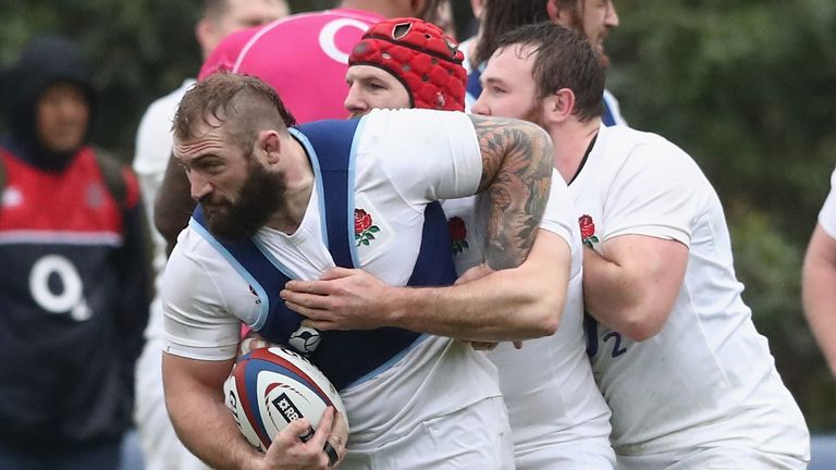 Joe Marler carries the ball as James Haskell and Matt Mullan hold on during the England training session