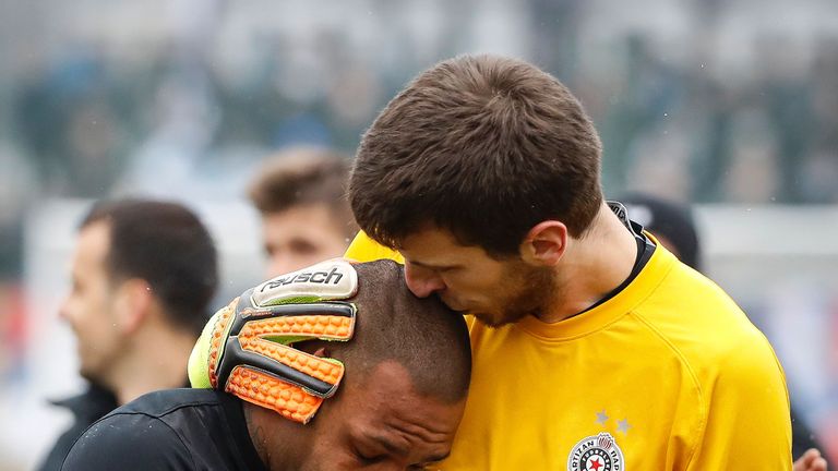 Partizan Belgrade's goalkeeper Filip Kljajic (R) hugs Brazilian midfielder Everton Luiz as he leaves the field in tears on February 19, 2017, at the end of