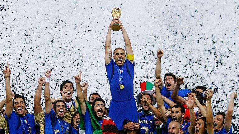 BERLIN - JULY 09:  The Italian players celebrate as Fabio Cannavaro of Italy lifts the World Cup trophy aloft following victory in a penalty shootout at th