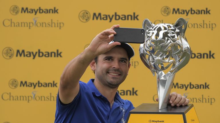 Fabrizio Zanotti of Paraguay takes a picture with his trophy after winning the final round of the 2017 Maybank Malaysia Championship golf tournament at Sau
