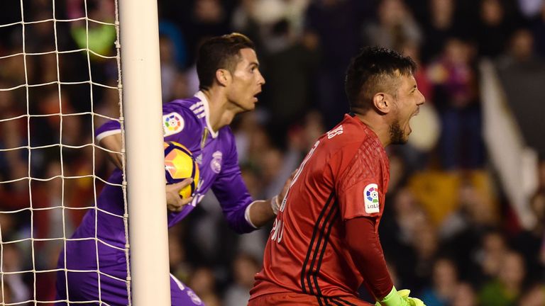 Valencia goalkeeper Diego Alves (R) shouts after Real Madrid's Cristiano Ronaldo scored during the Spanish league football match