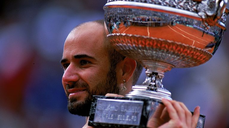 Andre Agassi of the USA holds up the trophy after defeating Andrei Medvedev of the Ukraine to win the men's singles final of the French Open