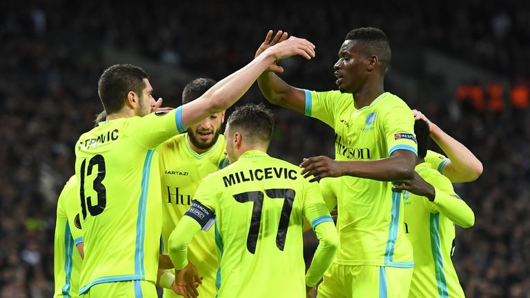 Gent players celebrate after Tottenham Hotspur's English striker Harry Kane scored an own goal to level the scores 1-1 during the UEFA Europa League Round 