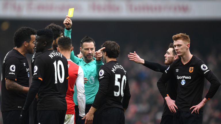 LONDON, ENGLAND - FEBRUARY 11: Kieran Gibbs of Arsenal is shown a yellow card by referee Mark Clattenburg during the Premier League match between Arsenal a