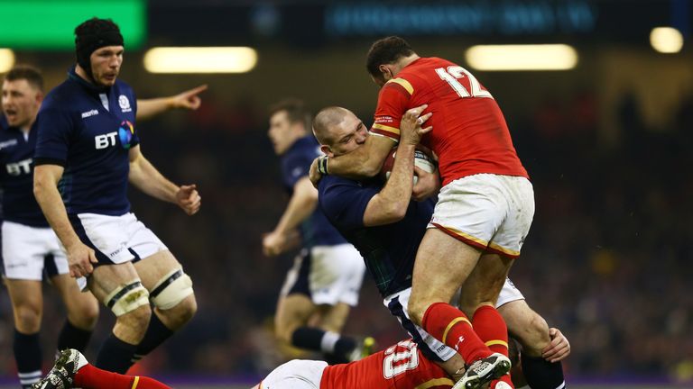 CARDIFF, WALES - FEBRUARY 13:  Gordon Reid of Scotland is tackled by Dan Lydiate and Jamie Roberts of Wales during the RBS Six Nations match between Wales 