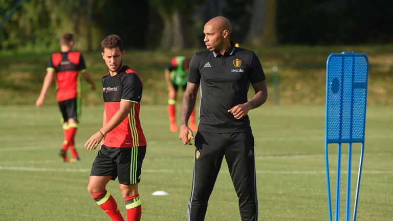 Belgium's national team assistant coach Thierry Henry (R) looks on next to Belgium's forward Eden Hazard during a training session, three days before their