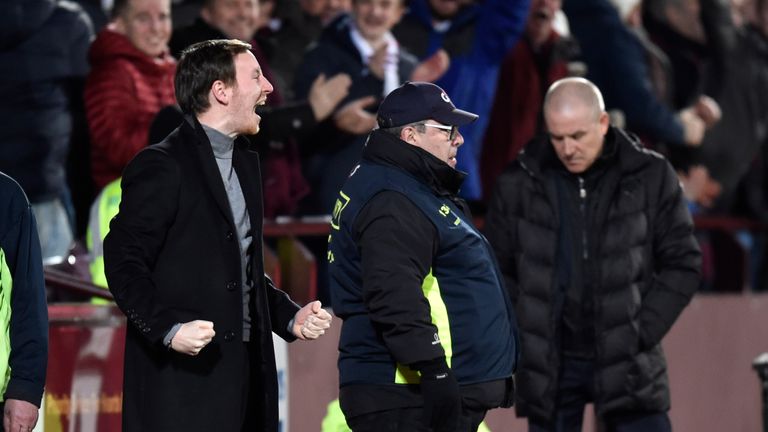 Hearts head coach Ian Cathro celebrates as Rangers manager Mark Warburton looks dejected