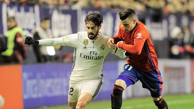 Real Madrid midfielder Isco (left) vies with Osasuna's midfielder Alex Berenguer