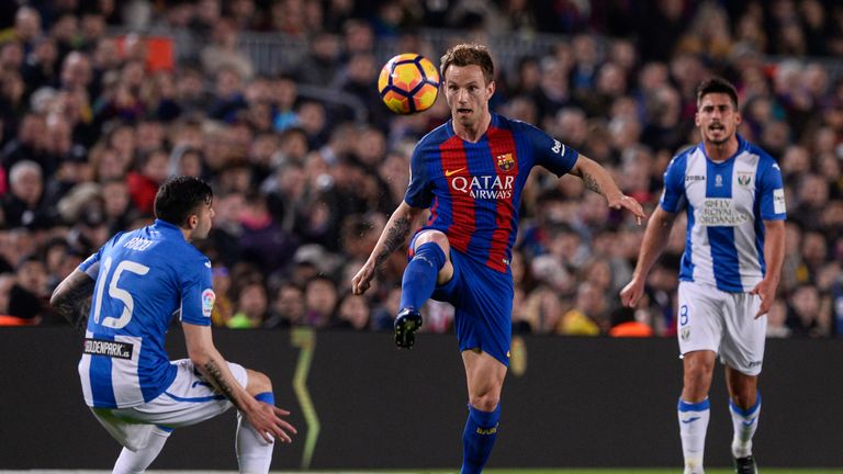 Leganes' defender Diego Rico (L) vies with Barcelona's Croatian midfielder Ivan Rakitic during the Spanish league football match FC Barcelona vs CD Leganes