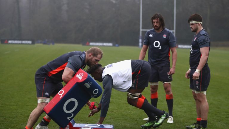 BAGSHOT, ENGLAND - JANUARY 31:  Maro Itoje charges into the tackle bag held by James Haskell as Tom Wood and Jack Clifford (R) look on during the England t