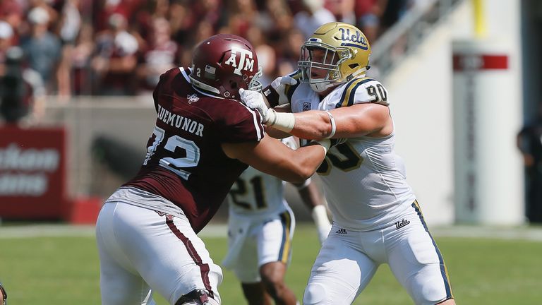 Jermaine Eluemunor #72 of the Texas A&M Aggies and Rick Wade #90 of the UCLA Bruins lock up on the play at Kyle Field 