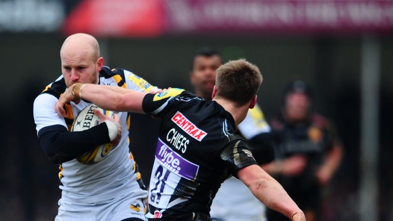 EXETER, UNITED KINGDOM - FEBRUARY 12: Joe Simpson of Wasps breaks the tackle of Stuart Townsend of Exeter Chiefs to goes over for his sides try during the 