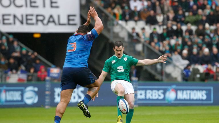 France's prop Uini Atonio (L) attempts to block a drop shot by Ireland's fly-half Jonathan Sexton during the Six Nations 2016