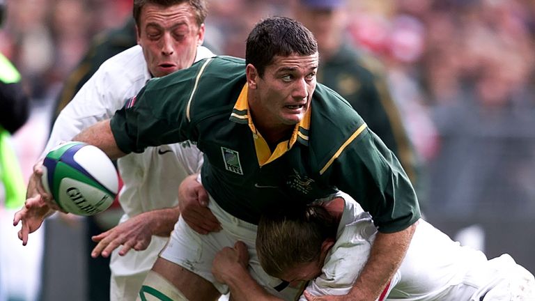 South African skipper Joost van der Westhuizen holds off England's Neil Back and Dan Luger (left), during their Rugby World Cup quarter final match