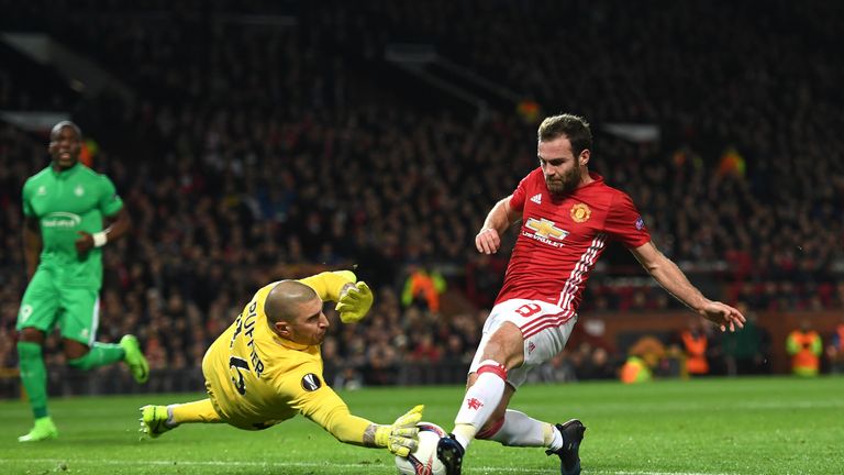 Stephane Ruffier of Saint-Etienne attempts to stop Juan Mata of Manchester United during the UEFA Europa  League 